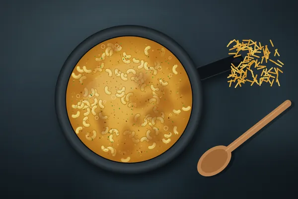 Smoked mac and cheese with a browned cheese crust in a cast-iron skillet, with a wooden spoon and shredded cheddar